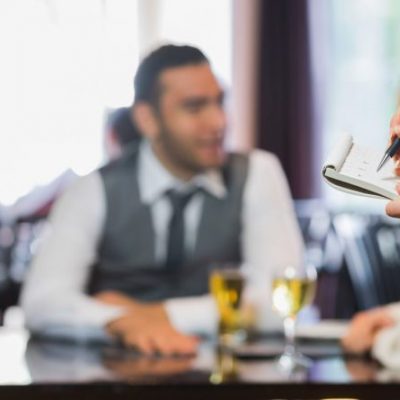 Server taking order for a table of people