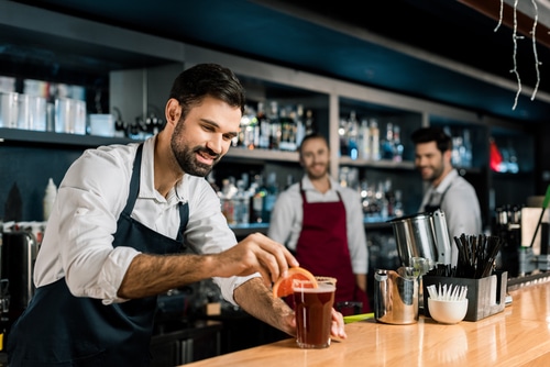 bartenders and servers behind the bar