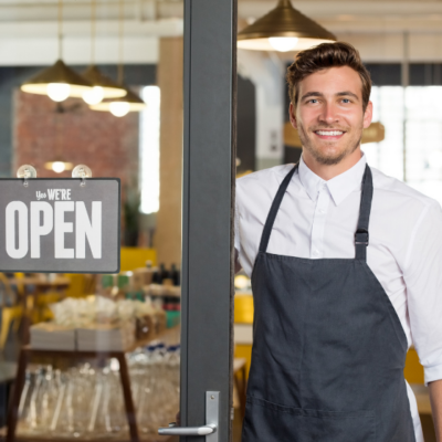 man with open sign at doorway