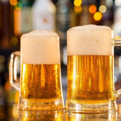 beer mugs filled on the bar up close