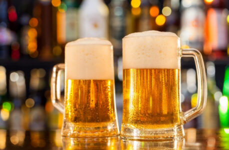 beer mugs filled on the bar up close
