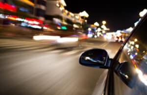 blurred street and car side mirror