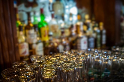 drink glasses organized behind the bar